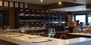 tasting bar with glasses and wine bottles on the shelf